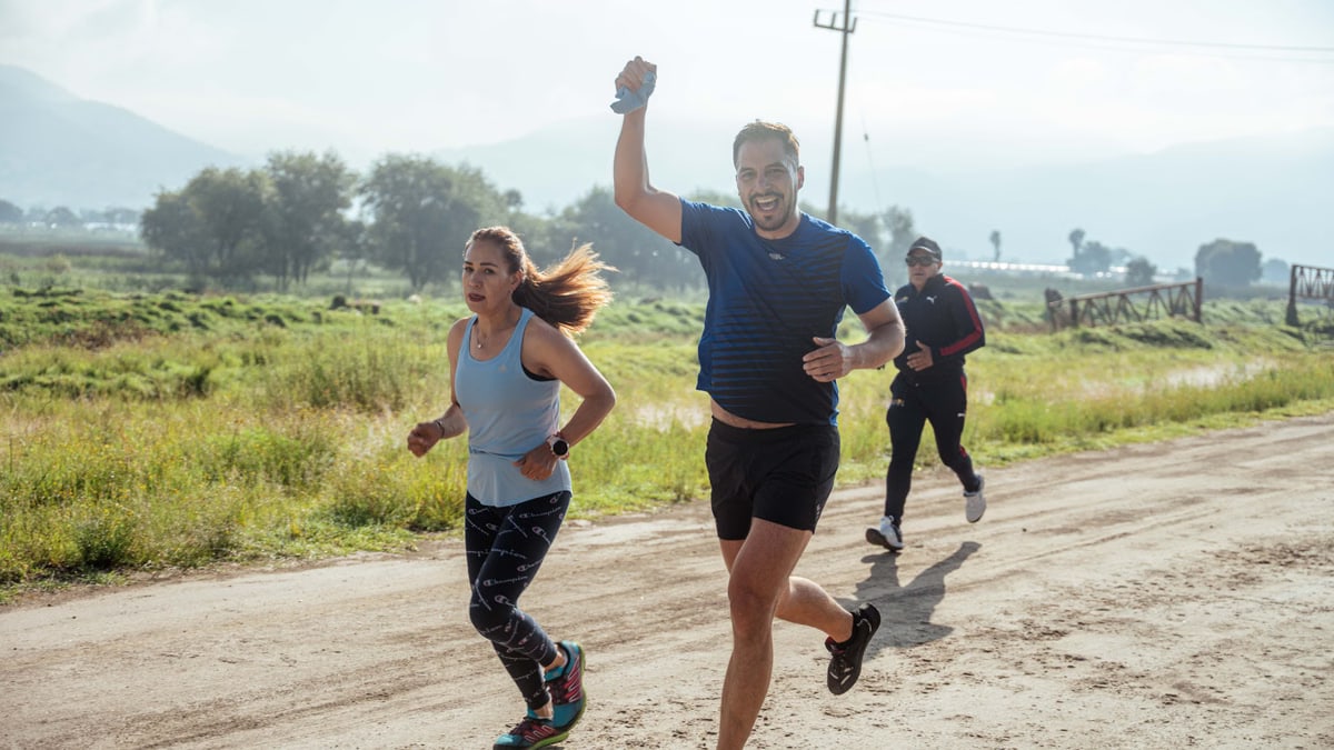 Group of people enjoying a morning run on a rural trail, embracing fitness and vitality.